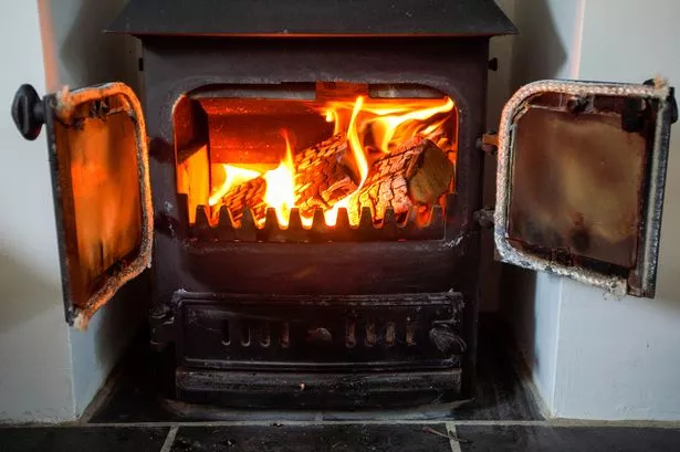 Wood stove burning: keep ventilation, chimney care, CO/smoke alarms, and clear zones front and center.
