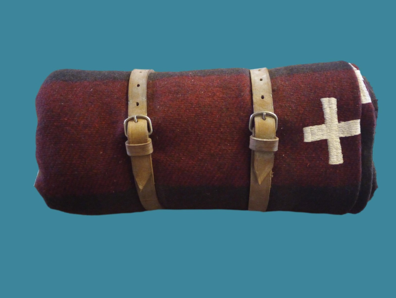 Rolled wool blanket with leather straps